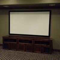 This dedicated theater features quality speakers from KEF, electronics from Marantz, Epson, Sunfire, and Screen Innovations. The front speakers are build into the cabinet, which was built to Ralph of Fine Wood Creation.