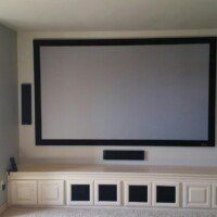 We used a Screen Innovations SLATE screen with KEF's T Series front speakers. All equipment is inside the custom cabinet.