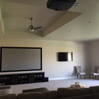 The 120" projection screen kind of dwarfs the 60", doesn't it? This room has dual purpose use, as the customer now has games to enjoy during the day and movies to watch at night!