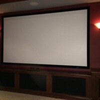 This was originally a game room that the customers wanted transformed into a theater room. Came out nice, don't you think? The KEF speakers are built in the front cabinet, and the equipment is all in a closet in the back of the room.