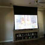 These customers wanted something a little larger and better than a big flat panel TV, so we build a projection screen into their ceiling. It is a very nice living room that transforms into a theater when they want to watch movies!