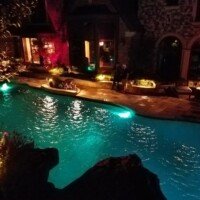 This pool has our custom lighting and a wonderful Landscape Series audio system, plus a large SunBrite outdoor television. They may never go indoors again!