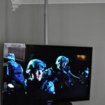 Sometimes, a pole mount works best. The center channel of this surround system is mounted directly underneath the TV...